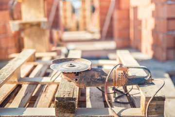 angle cutter, electric grinder and wooden blocks