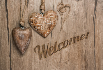 Wooden heart decorations and message "Welcome!"