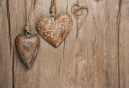 Wooden heart decorations on vintage oak background