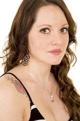 woman with long hair and rose tattoo on shoulder close looking