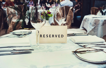 Reserved sign on a table in restaurant