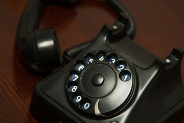 Old retro black telephone on desk