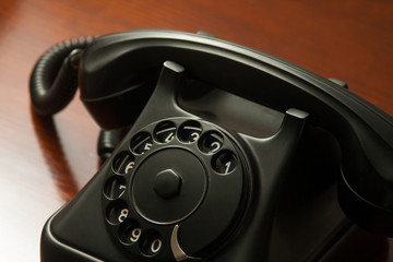Old retro black telephone on desk - obrazy, fototapety, plakaty