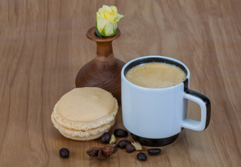 Coffee with macaroons and rose