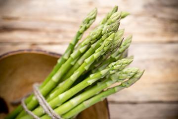 Asparagus on the wooden background.