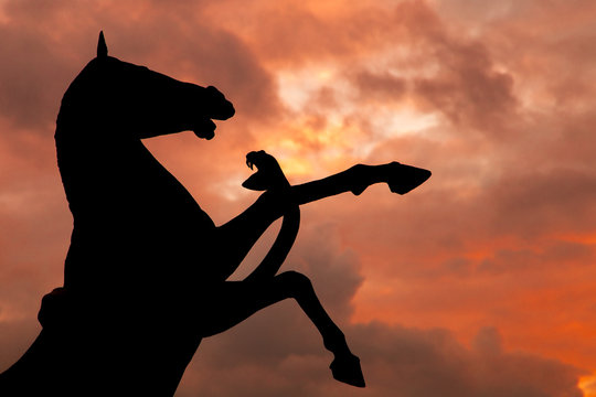 Horse and Snake monument silhouette with over cloudy red sky
