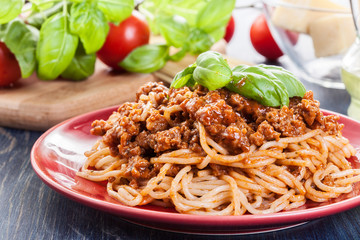 Spaghetti bolognese with cheese and basil