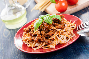 Spaghetti bolognese with cheese and basil