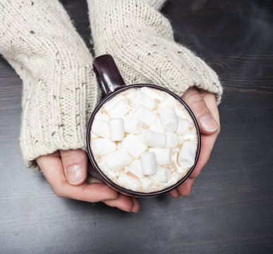 warm cup of cocoa in hands