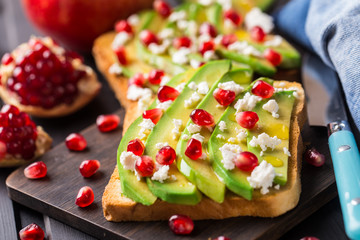 Avocado sandwich with feta and pomegranate