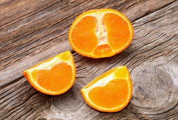 Ripe tangerines on wooden background