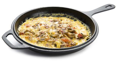 Homemade mushroom omlette in cast iron cooking pan