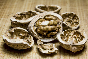 Chopped Walnut lies among the shells on a wooden board