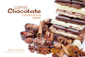 Various pieces of chocolate with nuts, raisins and coffee beans