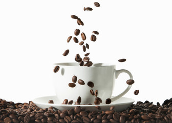 Coffee. White cup of coffee with roasted beans on white backgrou