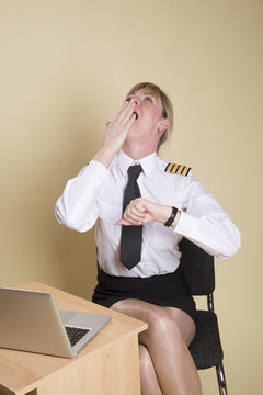 Tired female airline pilot wearing insignia of a captain