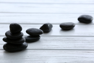 Spa stones with water drops on wooden background