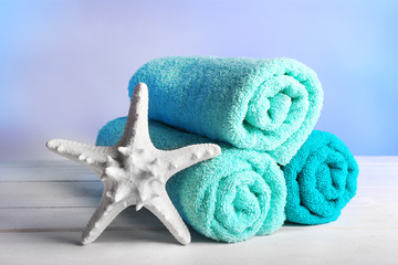 Obraz na płótnie Canvas Rolled towels with starfish