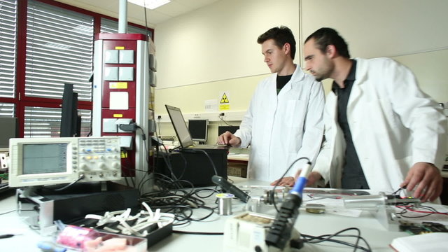 Team of scientists doing research in a high-tech physics lab