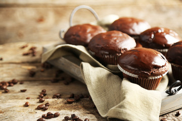 Tasty homemade chocolate muffins on wooden table
