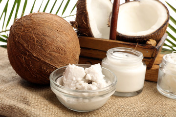 Coconut with jars of coconut oil and  cosmetic cream