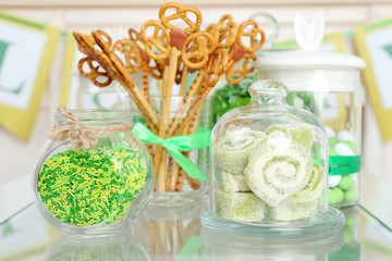 Composition for St Patrick Day with sweets on table close up