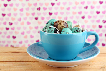 Bird colorful eggs in mug on bright background
