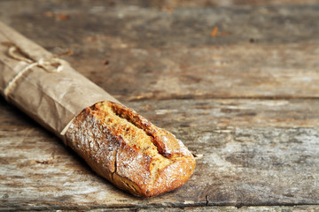 Fresh bread on old wooden table