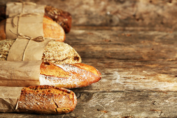 Different fresh bread, on old wooden table