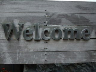 A metal Chinese word Welcome sign panel  on timber board