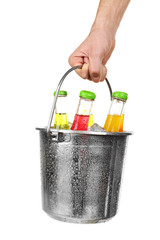 Female hand with metal bucket of alcoholic cocktails isolated