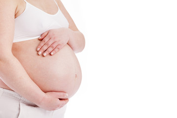 Close up of a pregnant belly, isolated on white background