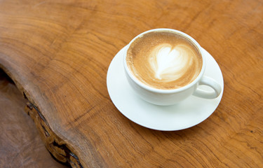 heart pattern latte coffee on the wooden table