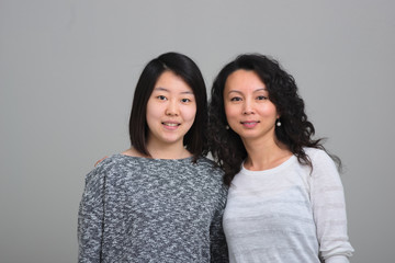 Two asian women smiling