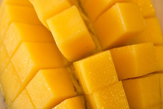 Fresh yellow mango cut close up.