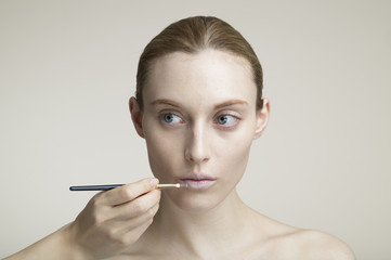 Obraz premium Lip brush and young women