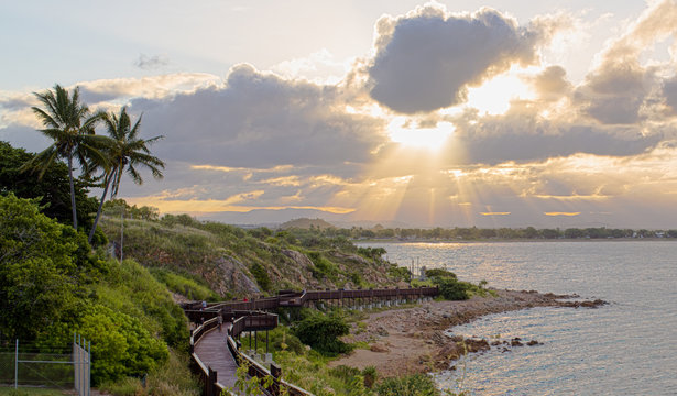 Tropical sunset with a view of wooden bridge over the rocky coas