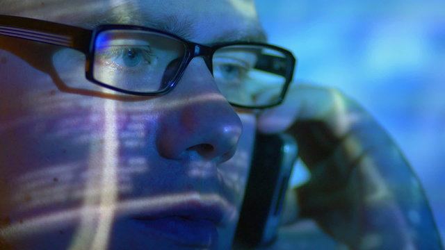 The man look through glasses and make a phone call