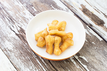 Deep-fried dough stick on wood