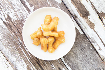 Deep-fried dough stick on wood