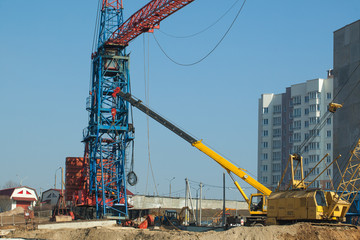 Fototapeta na wymiar Fitting and Installation a construction crane at a building site