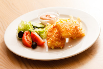 fried cheese with salad and potaotes