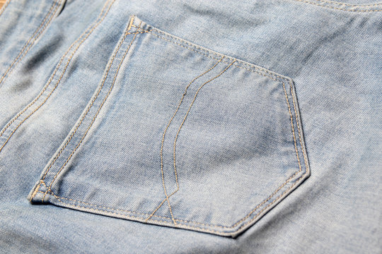 close up of old jeans back pocket