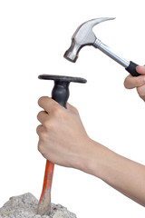 Male hands working with hammer and chisel.
