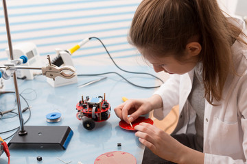 Girl Solder and adjust Electronic Device