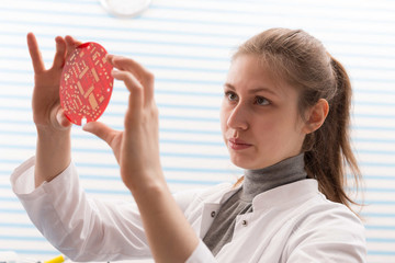 Girl Solder and adjust Electronic Device