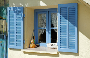 Opened blue window shutters