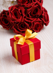red flowers and gift box with yellow ribbon