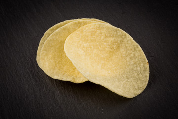Potato chips on a black background