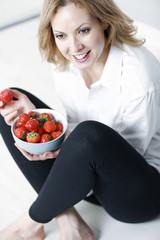 Woman eating fresh strawberries